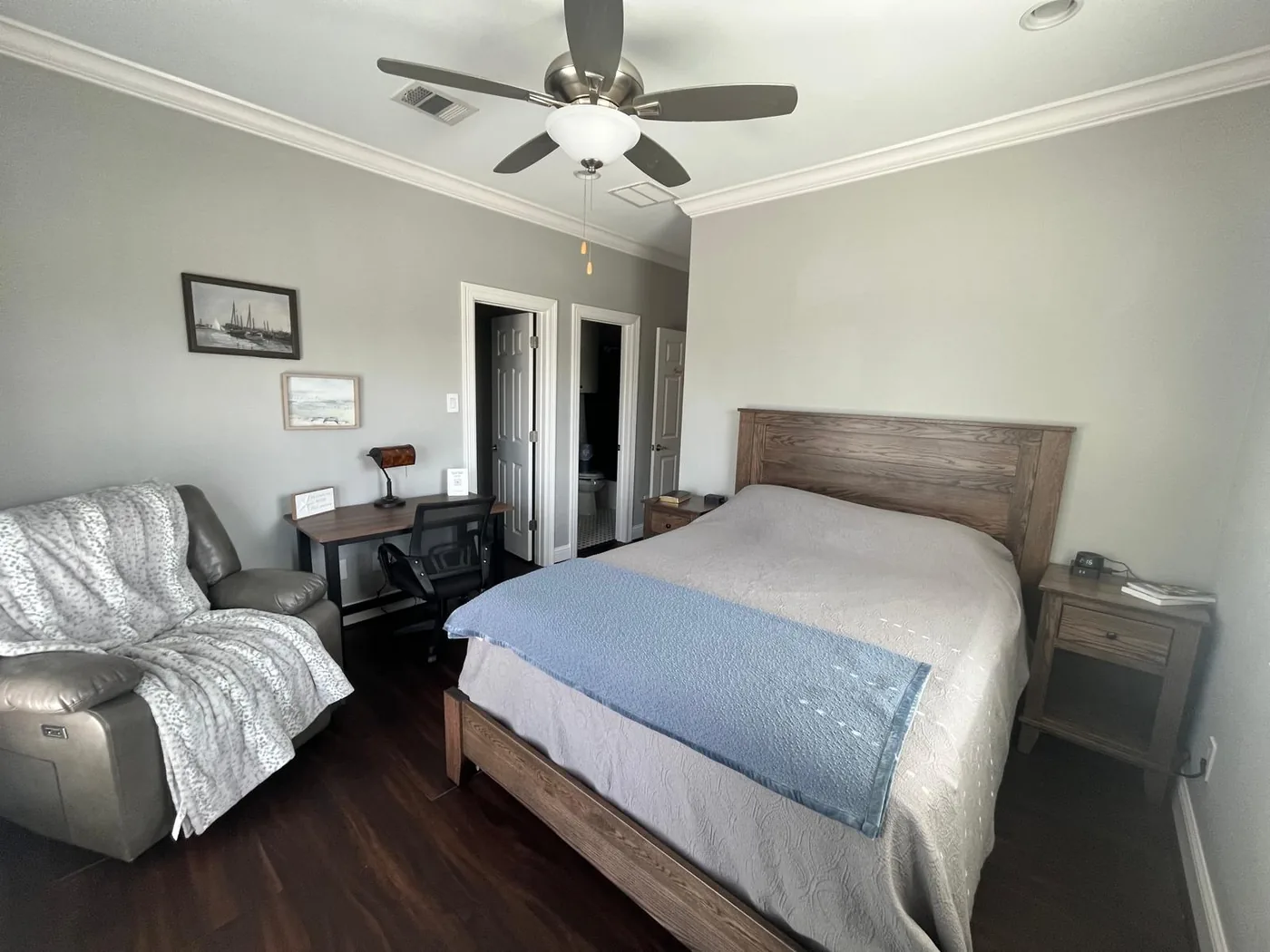 Room 3, with a queen bed, a gray recliner and a writing desk